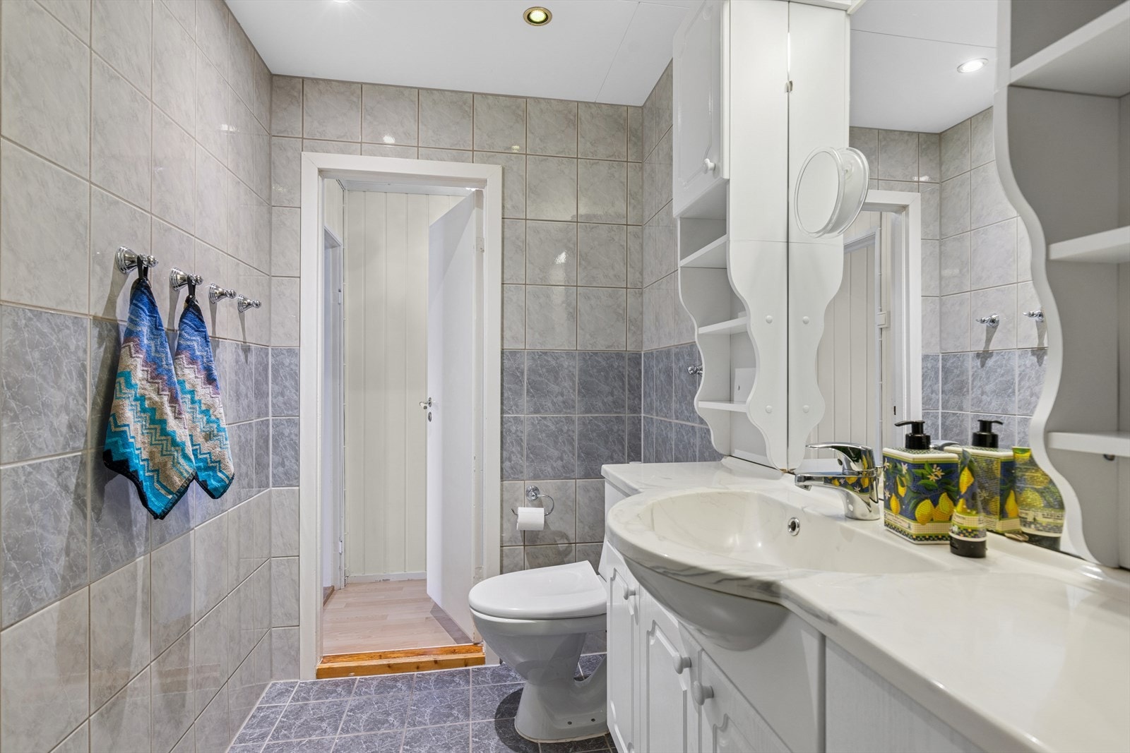 Det er fliser på gulv med elektriske varmekabler, og flislagte vegger. Downlights i taket. Galleribilde