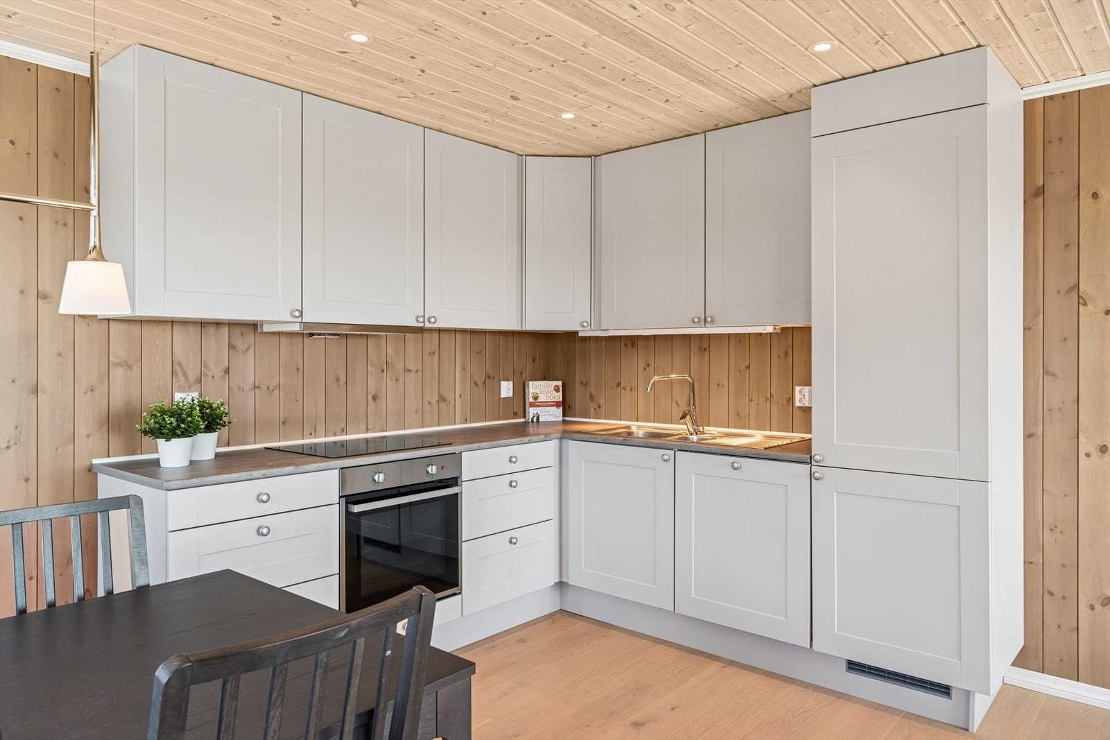 Lyst kjøkken med integrerte hvitevarer og oppvaskmaskin. Galleribilde