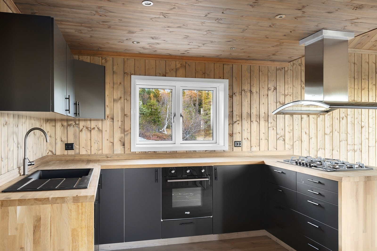 Benkeplate i heltre med nedfelt vaskekum og gjennomført uttrykk i materialvalg og farger. Galleribilde