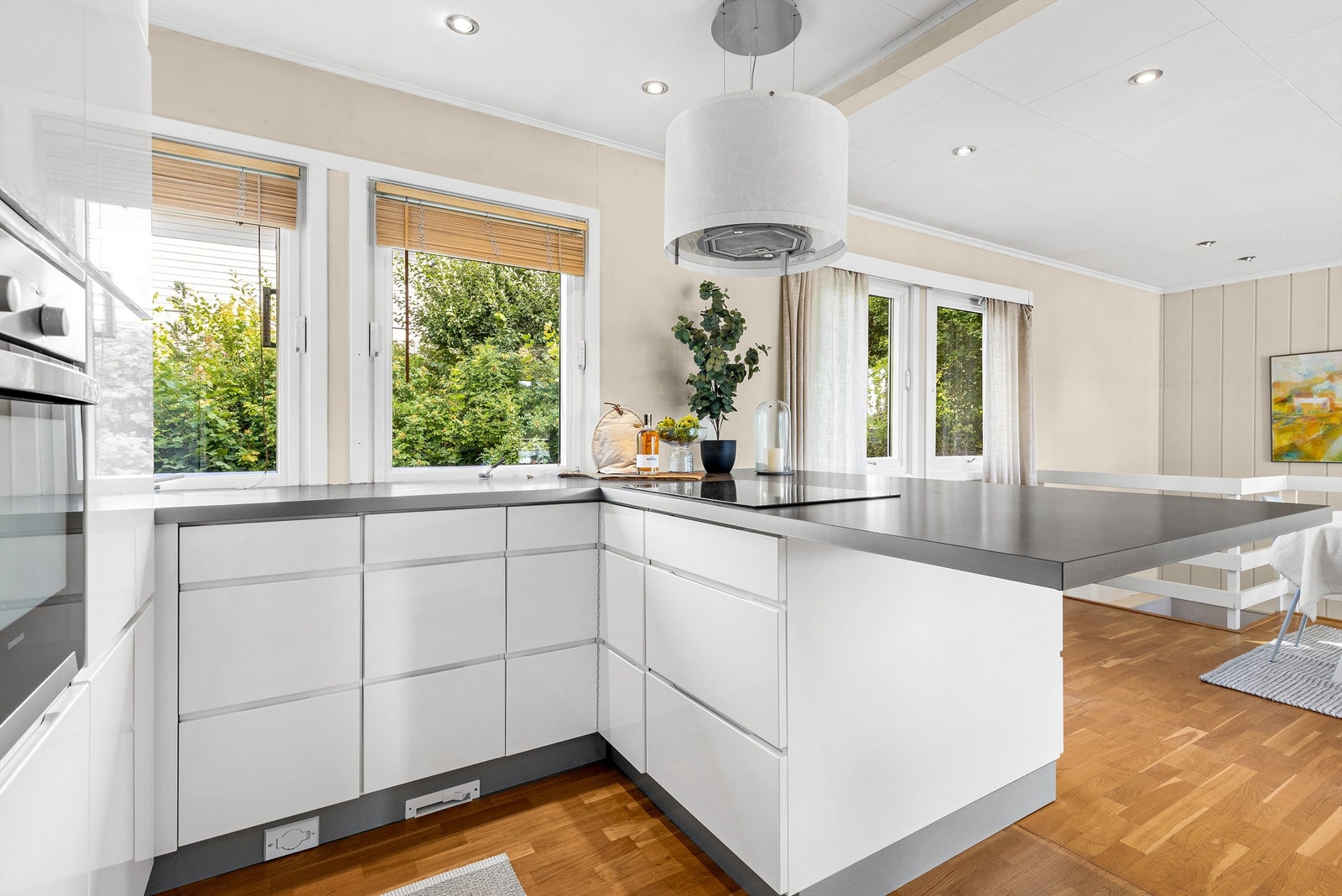 Kjøkkeninnredning med slette fronter fra omkring 2011. Benkeplate av laminat. Planlimt oppvaskkum i rustfritt stål med ett-greps armatur. Fliser og stikkontakt på vegg over kjøkkenbenk. Galleribilde