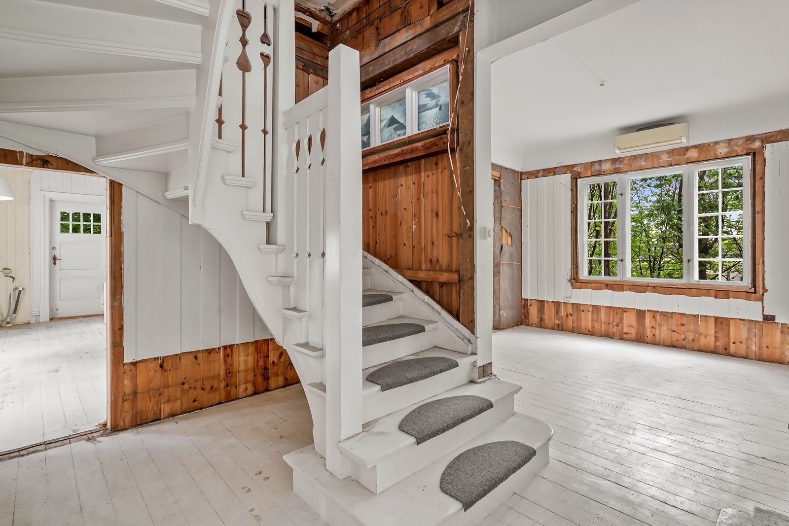 Malt tretrapp med teppe i gangsone. Rekkverk med stående malte spiler. Galleribilde