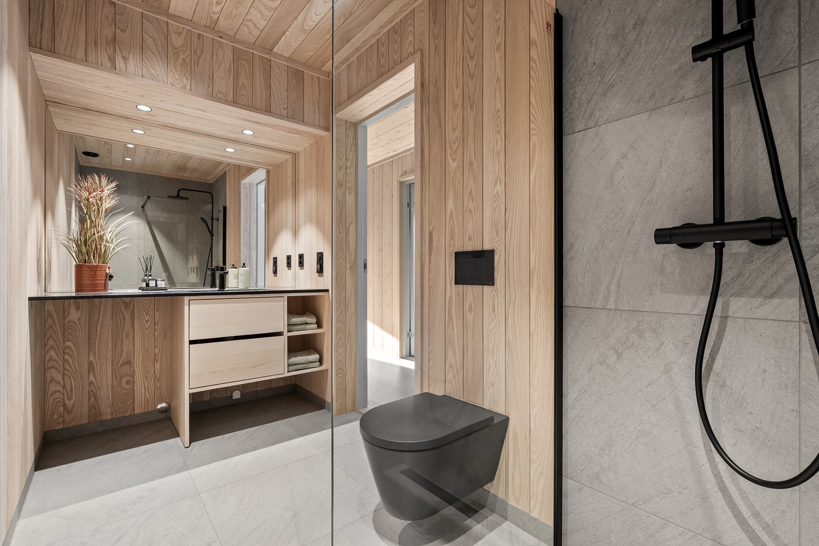 Delikat bad med storformatfliser fra italienske Cæsar Ceramiche og panel i ask som gir en harmonisk og moderne stil Galleribilde