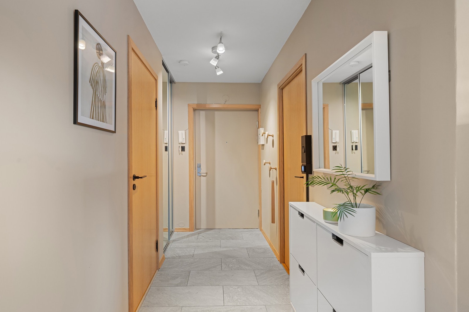 Lys og innbydende entré med flislagt gulv. I 2025 ble alle innerdører, karmer og lister skiftet til kompakte dører i eikefinér med tilhørende detaljer i eik. Galleribilde