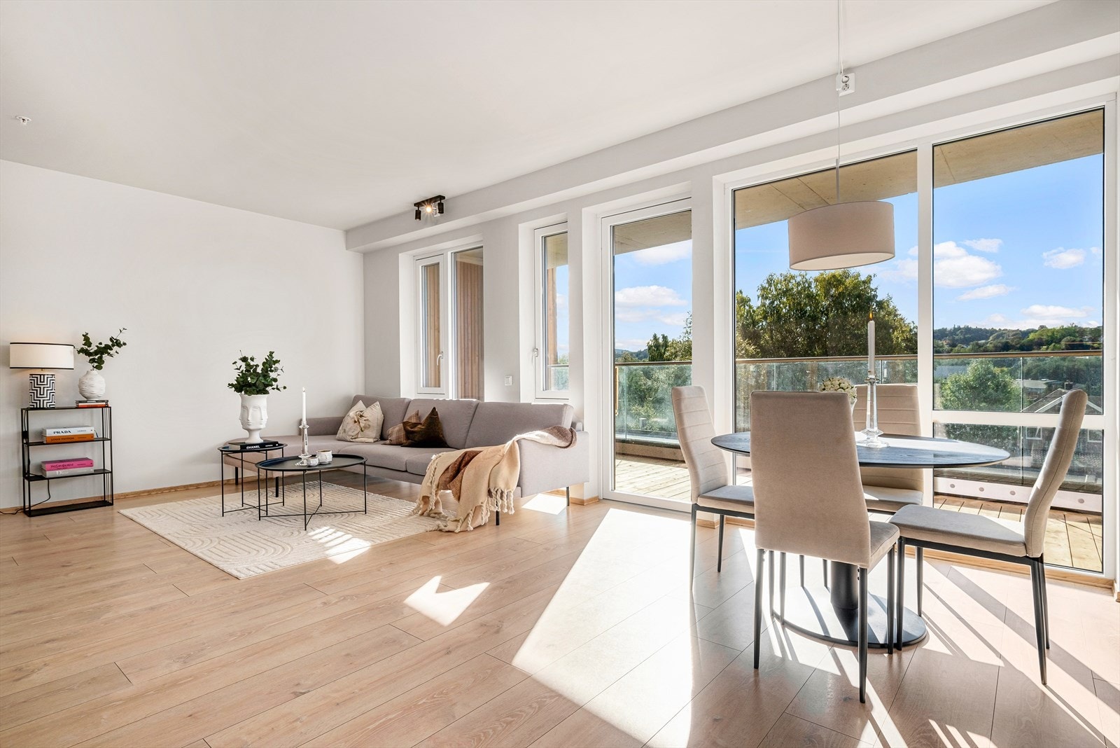 Store vindusflater gir godt med naturlig lysinnslipp i leilighetens oppholdsrom. Galleribilde