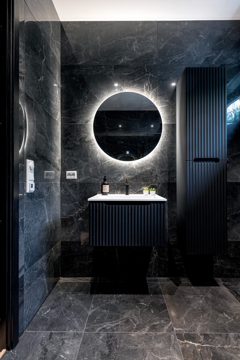 Stilren innredning med servant, høyskap og lys i speilet Galleribilde