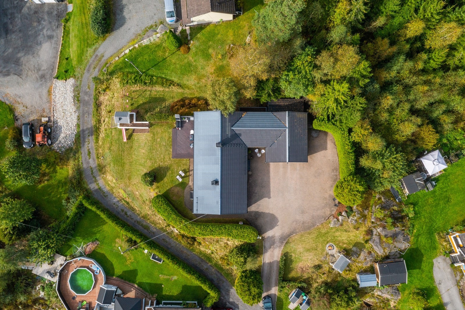 Innkjørselen er opparbeidet med belegningsstein og god plass til parkering. Galleribilde