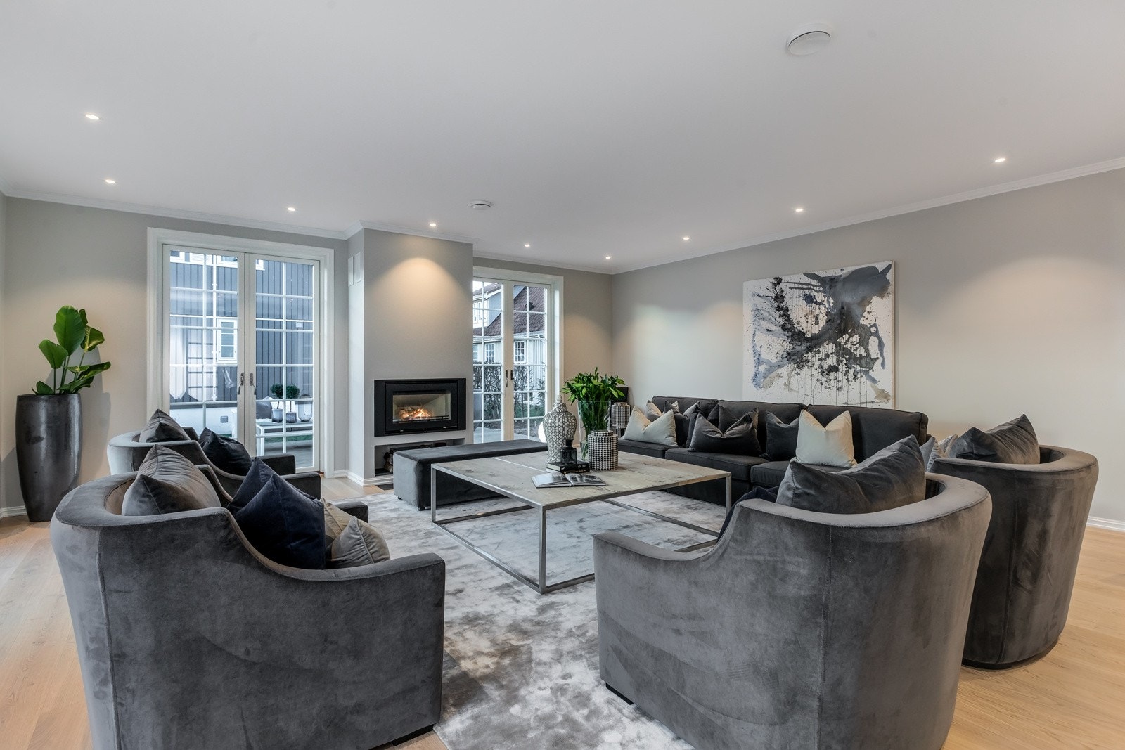 Illustrasjonbilder. Romslig stue med store vindusflater og utgang til markterrasse. Galleribilde