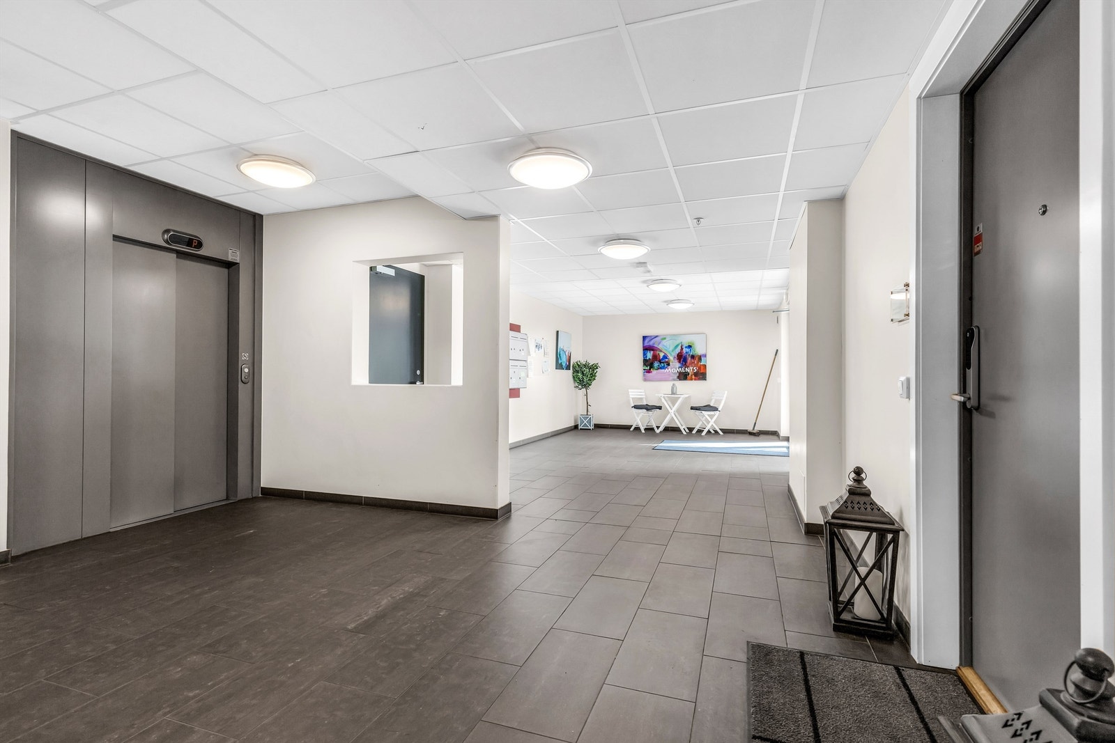 Oppgangen har godt med plass og det er adkomst både via ytterdør og fra heis. Dør på høyre side er inn til leiligheten. Galleribilde