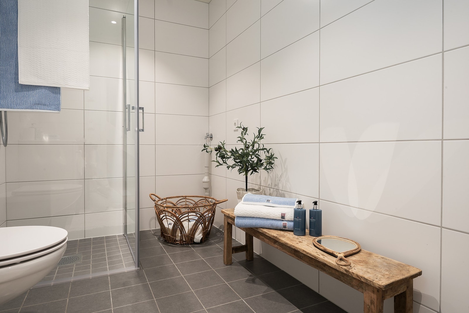 Badet er innredet med praktiske dusjvegger og veggmontert toalett. Det er også lagt opp opplegg for vaskemaskin. Galleribilde