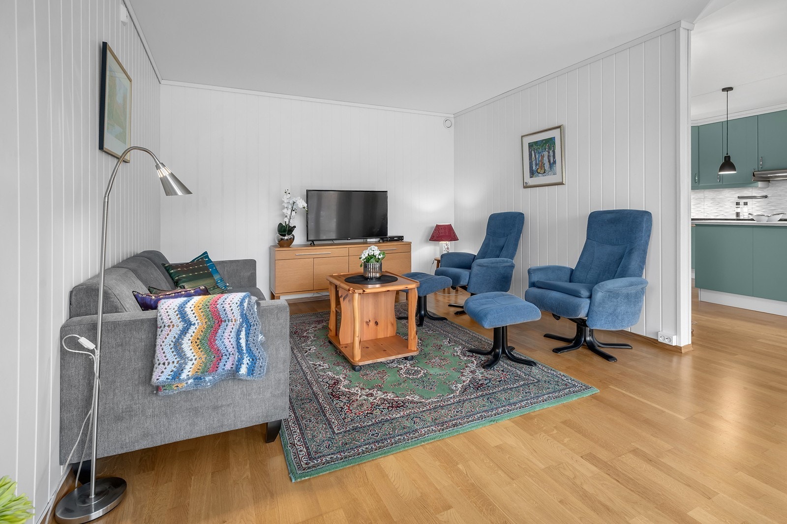 Stuen er delvis skilt av med vegg mot kjøkkenet. Galleribilde