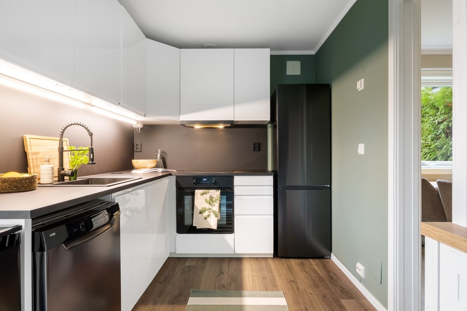 Kjøkkeninnredning med glatte fronter, laminat benkeplate med nedfelt vask. Galleribilde