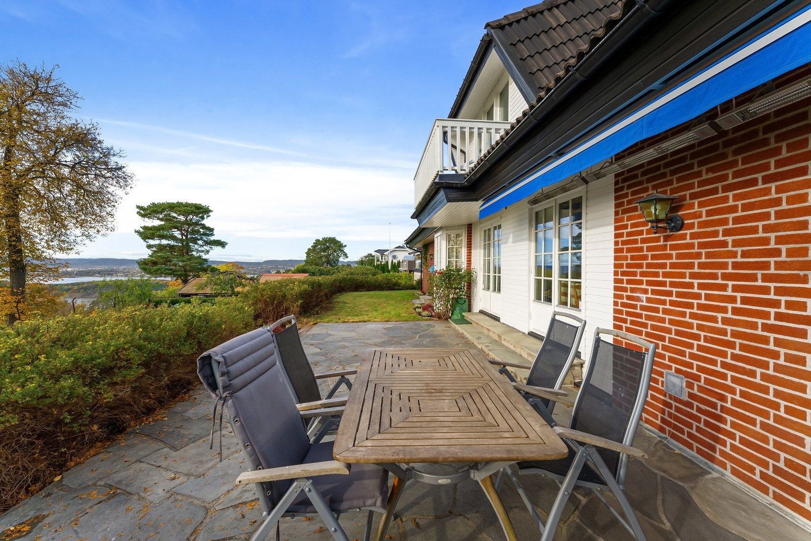 Skiferlagt terrasse med god plass til utemøblement og videre adkomst til hagen