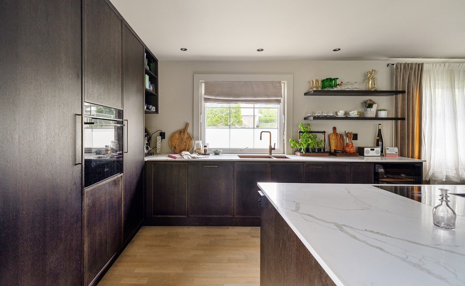 Kjøkken fra 2024 med innredning fra Epoq. Benkeplate i stein, planlimt vask og integrerte hvitevarer - inkludert vinskap, oppvaskmaskin og ventilator med kullfilter. Galleribilde