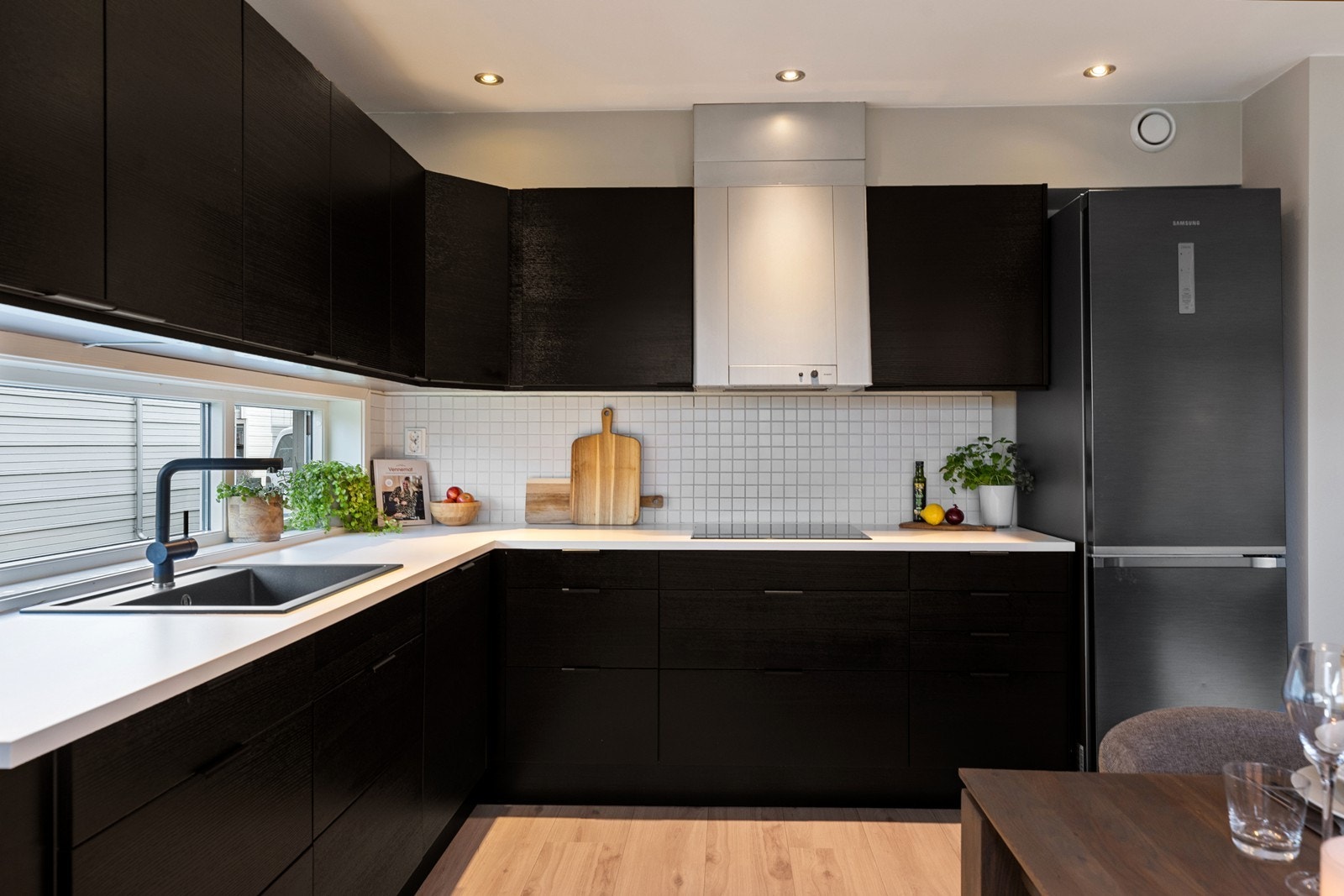 Godt med lys, både fra vinduet over benken ved vasken, under overskap og down lights i himlingen. Galleribilde