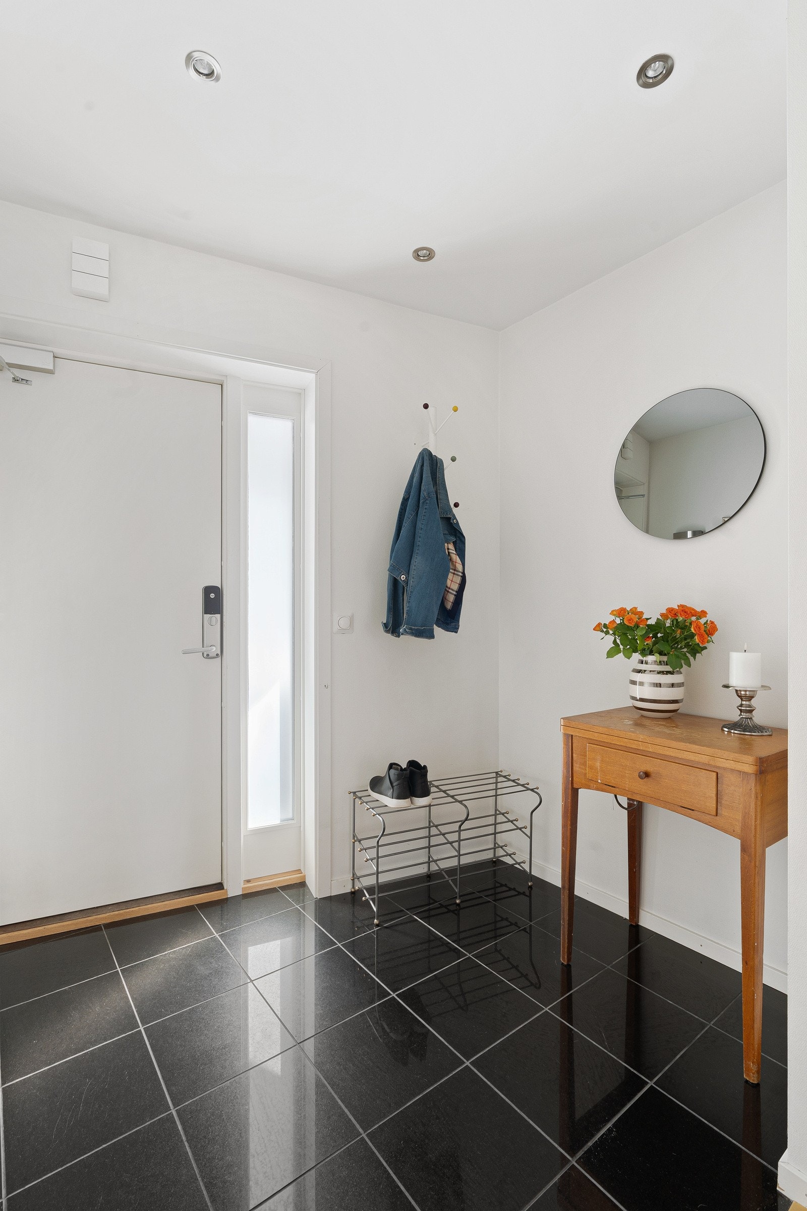 Velkommen inn! Her blir du møtt av et strøkent inngangsparti med god plass til oppheng av yttertøy og sko Galleribilde