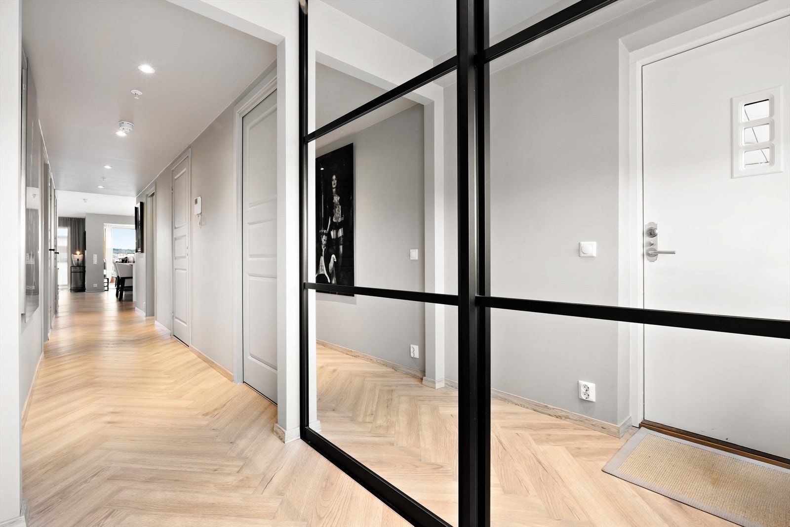 Velkommen inn i en lys og romslig og innbydende entré. Her er det montert skyvedørsgarderobe med speilfronter med god plass til yttertøy og sko. Galleribilde