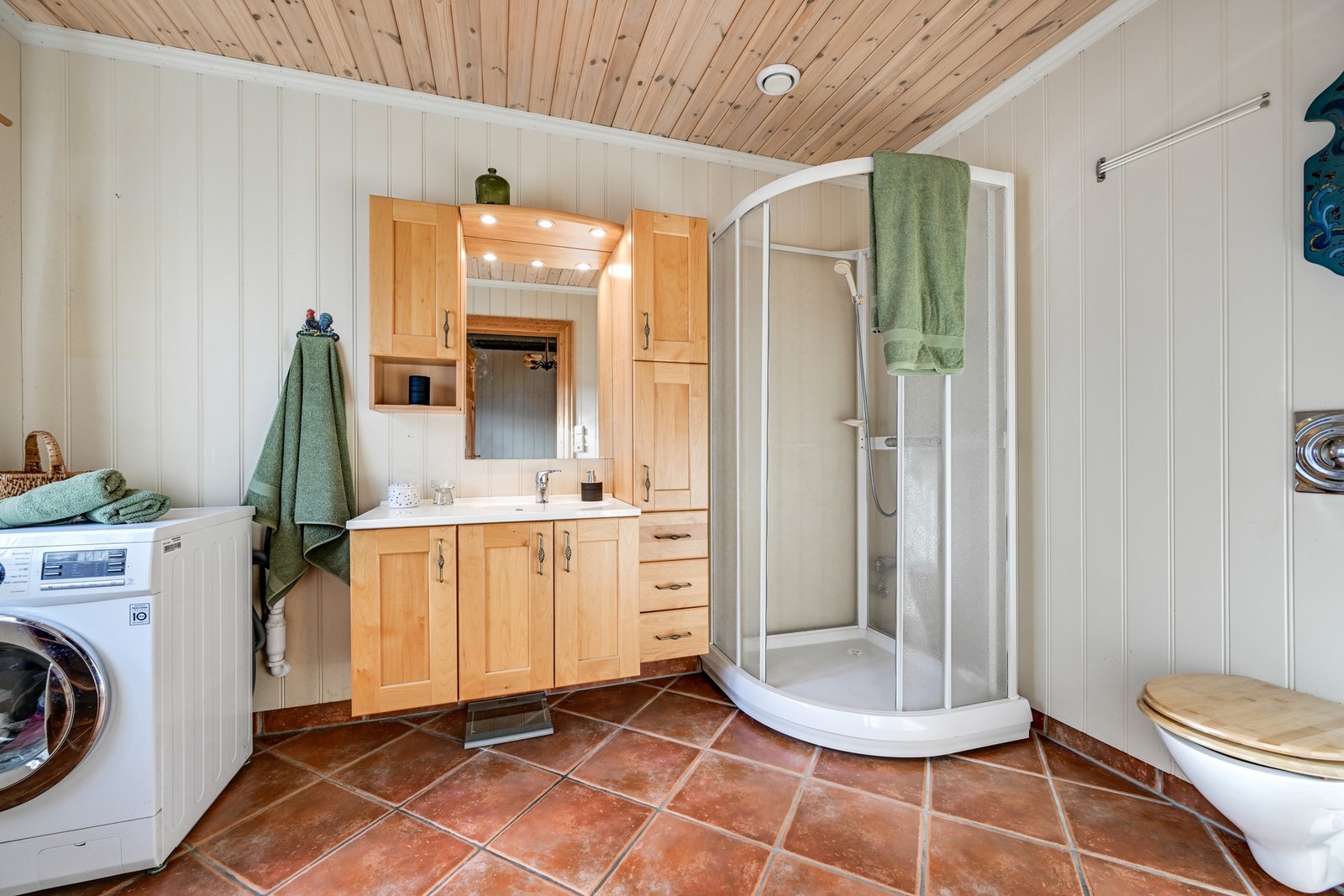 Baderom nr. 2 er et kombinert vaskerom med dusjkabinett og en solid baderomsinnredning med over og underskap/skuffer. Innredningen er av svartor, en detalj verdt å merke seg. Galleribilde