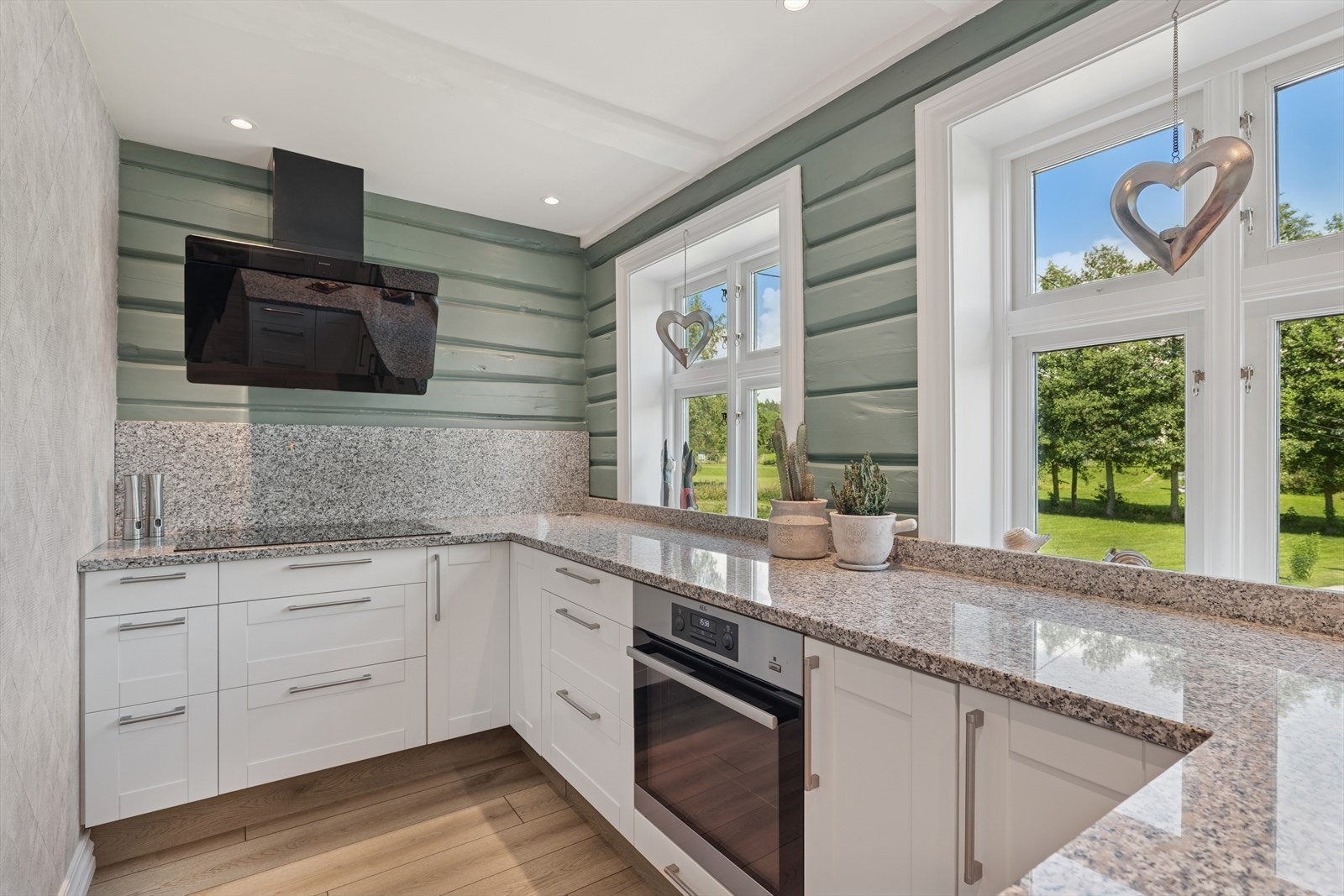 Praktisk arbeidsplass på kjøkkenet! Innredningen har et tidløst preg med lyse, profilerte fronter og benkeplate i stein. Galleribilde