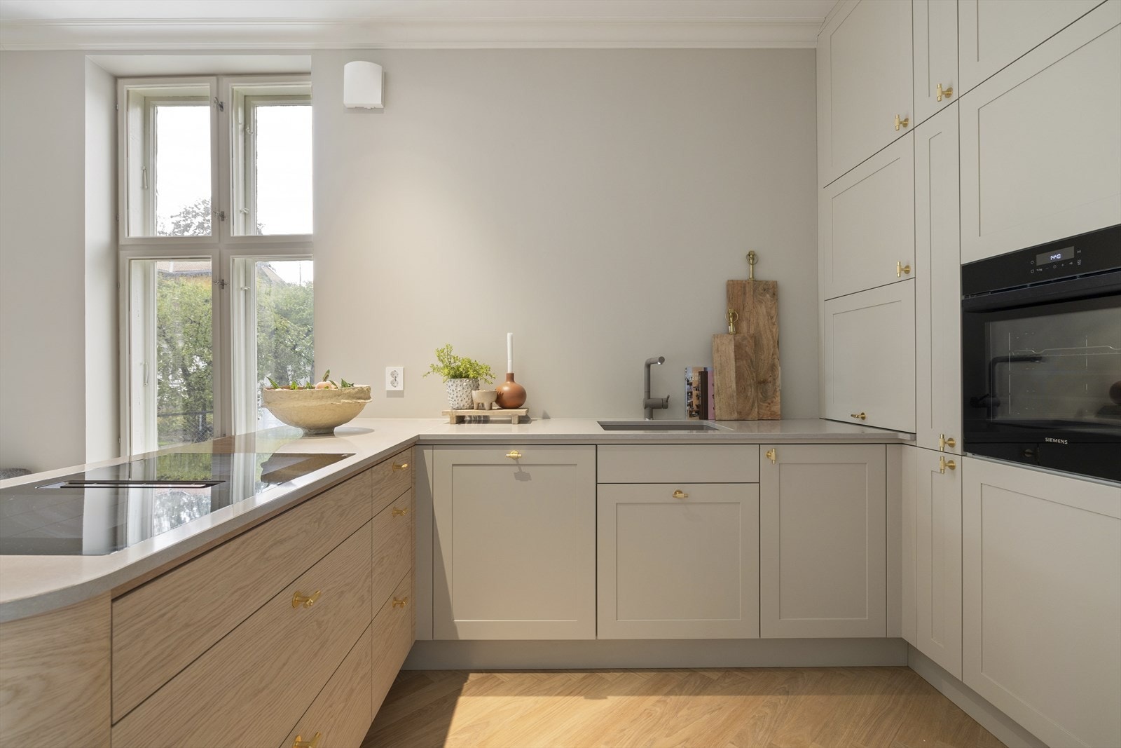 Kjøkkenet er skreddersydd og går helt opp til taket, noe som gir både et helhetlig design og ekstra oppbevaringsplass. Galleribilde