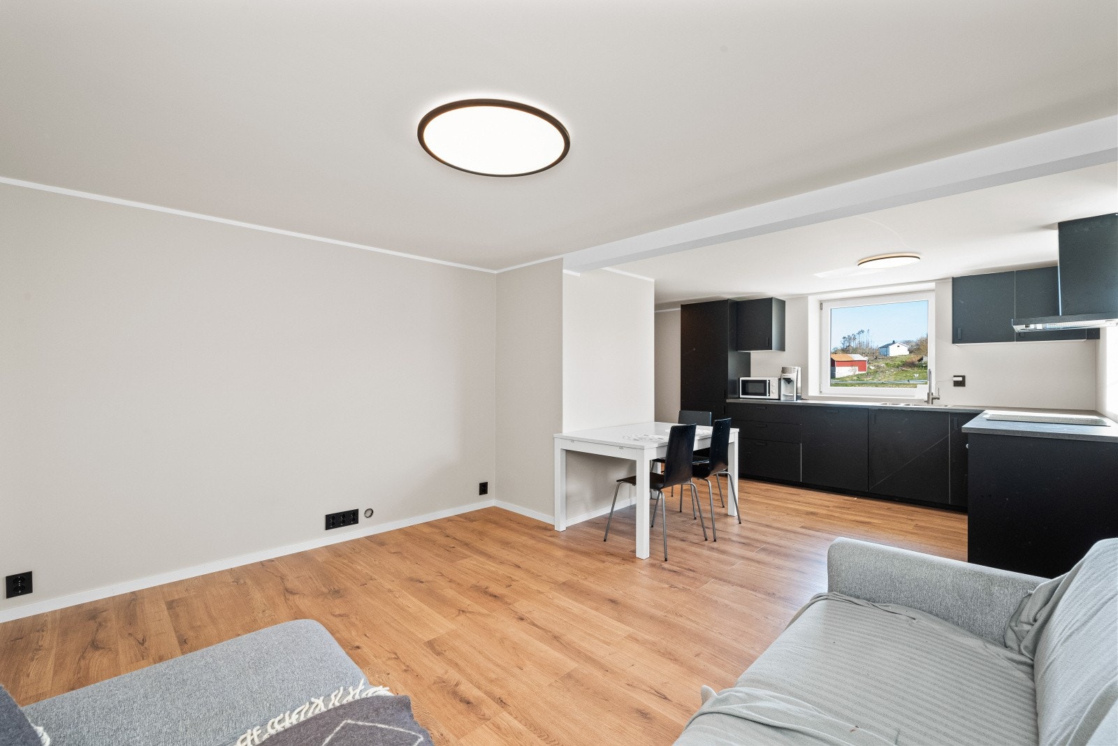 Stuen i underetasjen har plass til sofagruppe og tv-møbel, samt plass til spisebord overgangen mot kjøkkenet Galleribilde