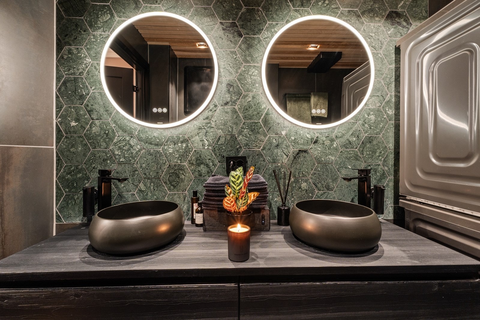 Badet har dobbel servant med skuffer, to speil med lys, vegghengt wc, regnfallsdusj og opplegg for vaskemaskin og tørketrommel. Galleribilde