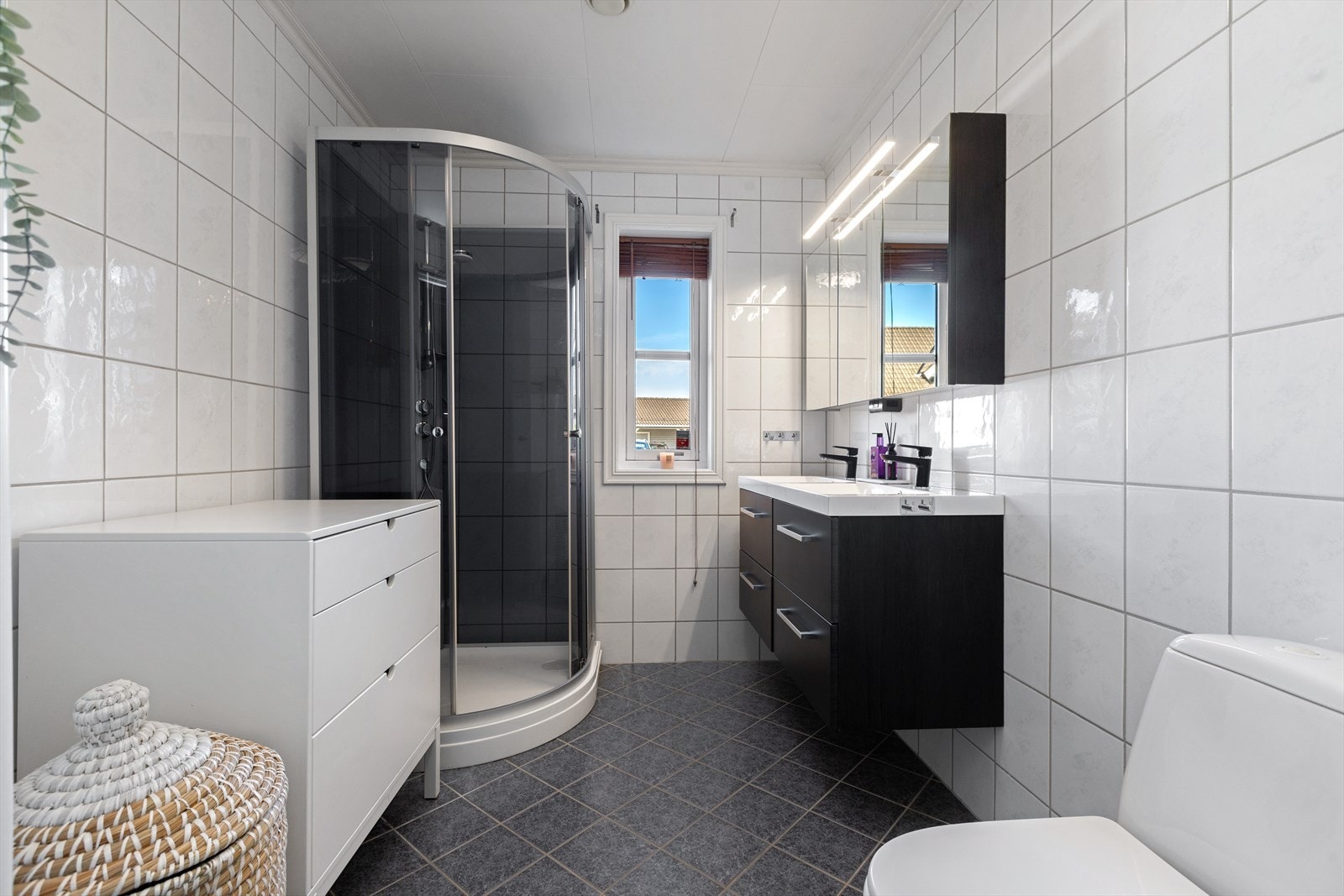 Baderommet i første etasje har keramiske fliser på gulv med varmekabel. Veggene har keramiske fliser og det er takplater i himlingen. Galleribilde