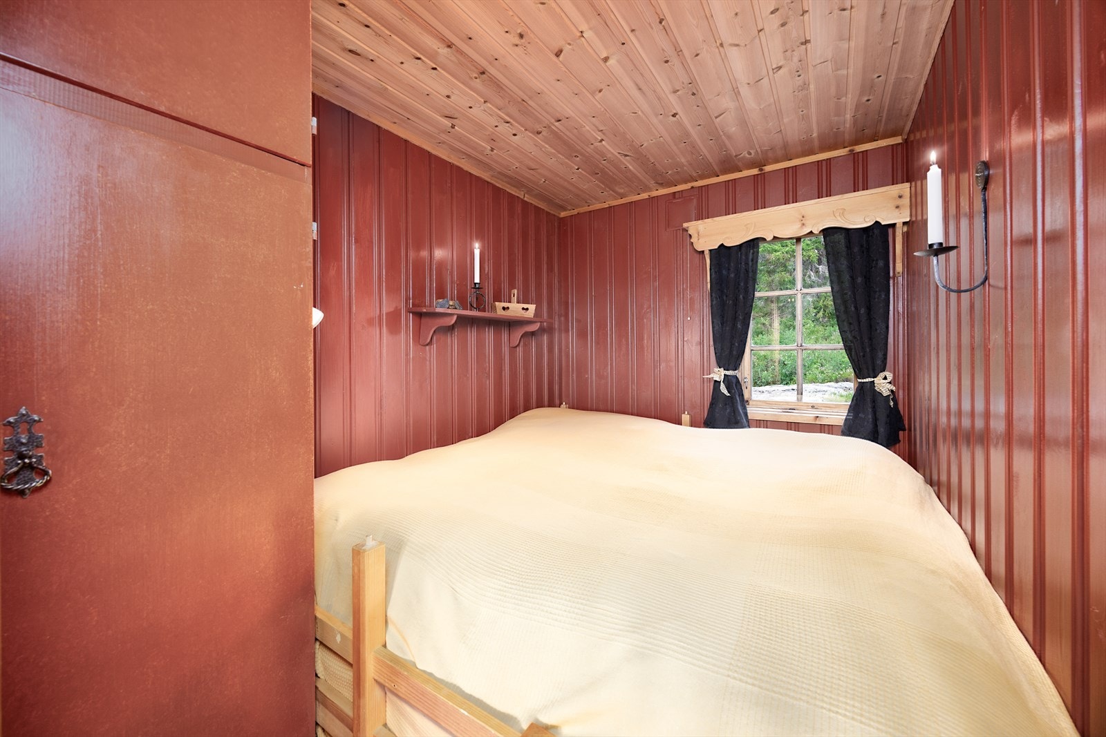 Soverommet ved peisen i hovedhytta. Vegg-til-vegg dobbeltseng kan erstattes med samme sengeløsning som det andre soverommet. Galleribilde