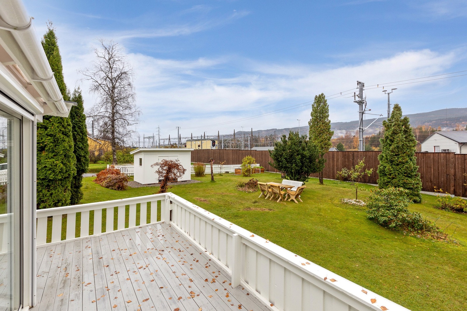 Her får du en god oversikt over det grønne uterommet - med plen, trær og frodig vegetasjon som gir et lunt og skjermet inntrykk. Galleribilde