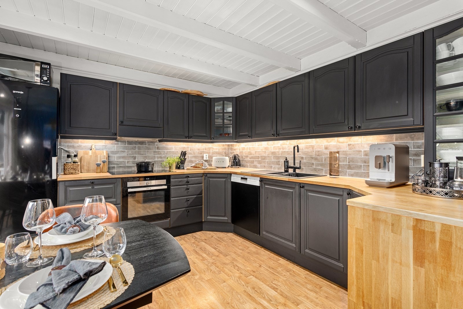 Kjøkkenet har innredning med profilerte frontar og benkeplate av heiltre. Av kvitevarer er det kjøleskåp, oppvaskmaskin, platetopp og steikeomn. Galleribilde