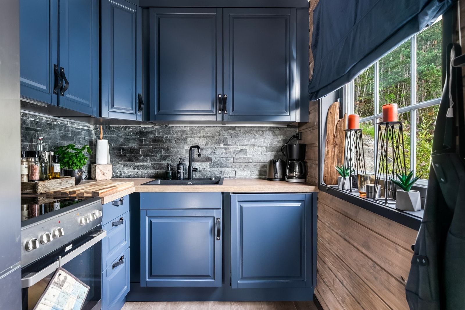 Det store vinduet slipper inn det naturlige lyset og gir kjøkkenet en varm og innbydende atmosfære. Galleribilde