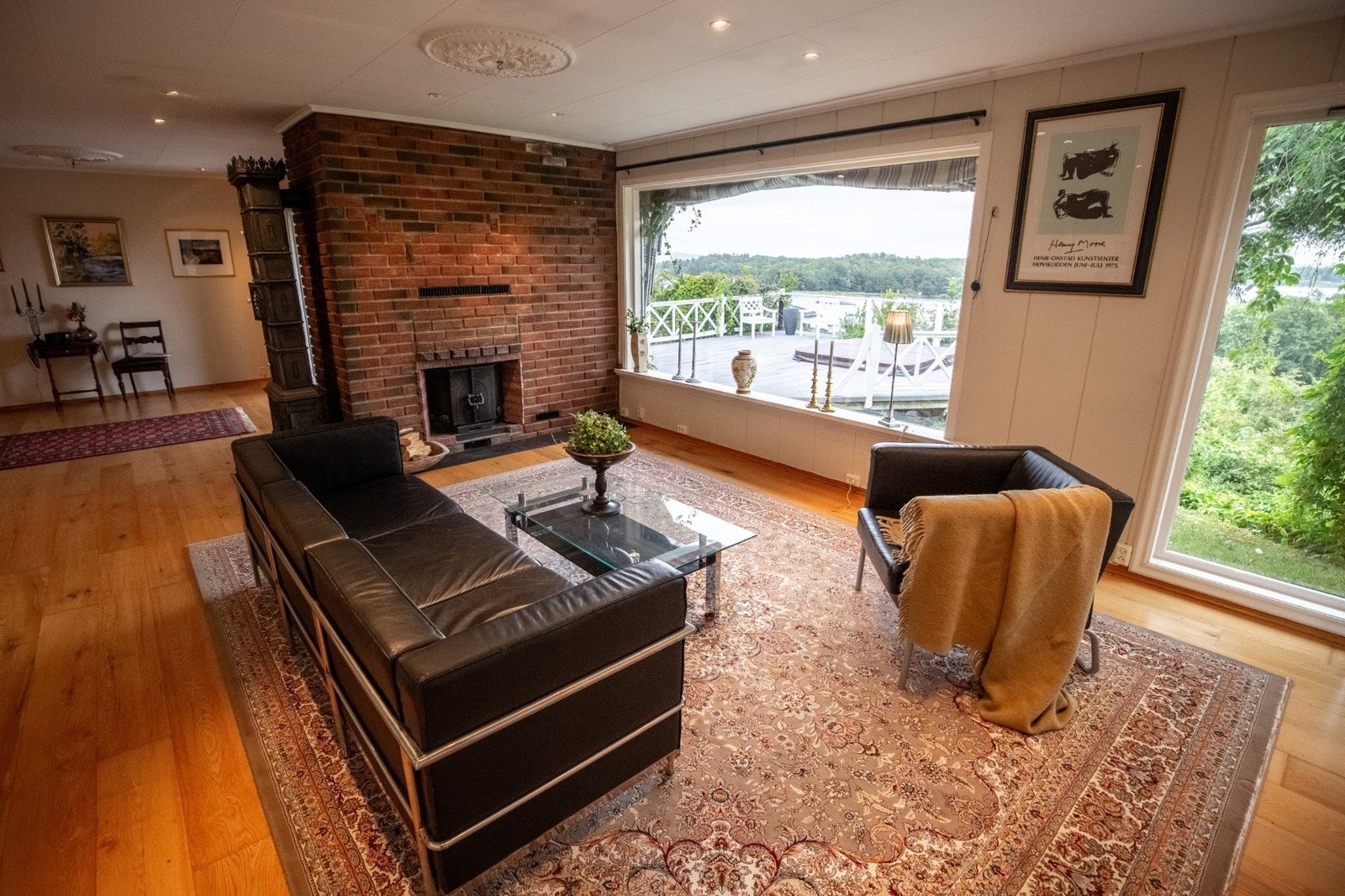 I stua er det både peisovn og en stilig etasjeovn - vi ser litt av terrassen i vinduet Galleribilde