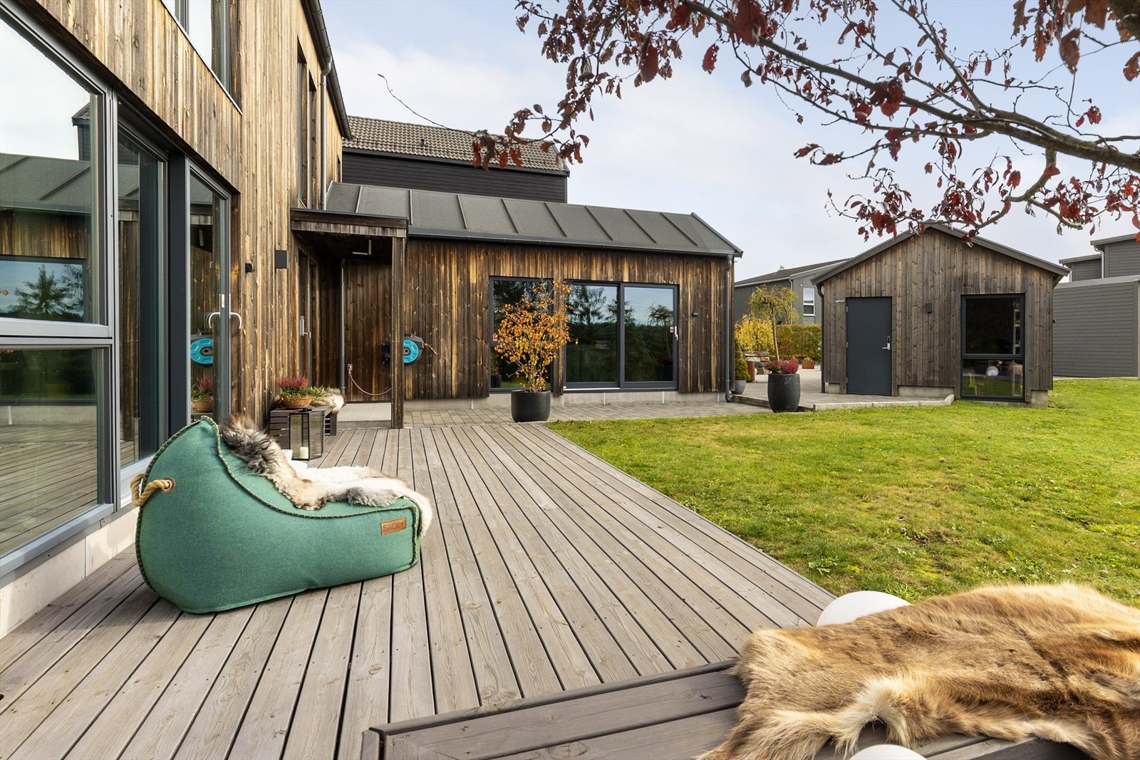 Her er det god plass til utemøblement, og i hjørnet ut mot hagen er det plantet et flott tre med sittebenk rundt. Terrassen strekker seg langs deler av boligens langvegg mot syd og hele kortveggen mot vest, og har direkte tilknytning til hagen. Galleribilde