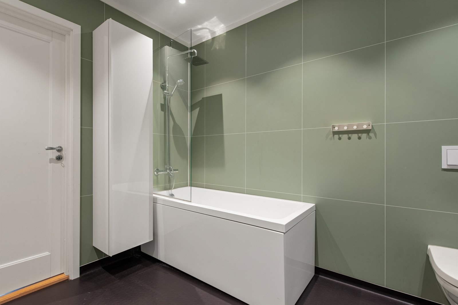 Badet har toalett, badekar og baderomsinnredning. Galleribilde