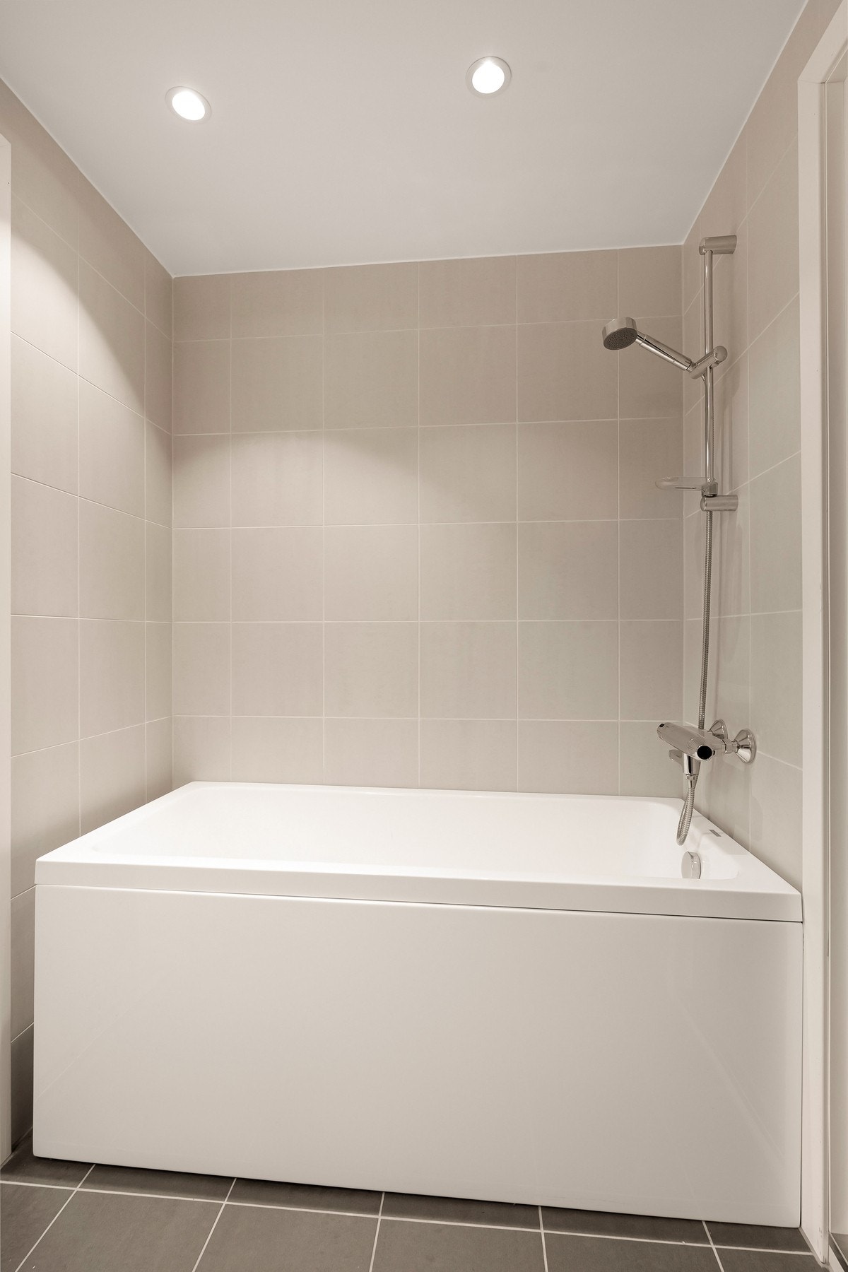 Masterbad (2022) med badekar, downlights og flislagte flater Galleribilde