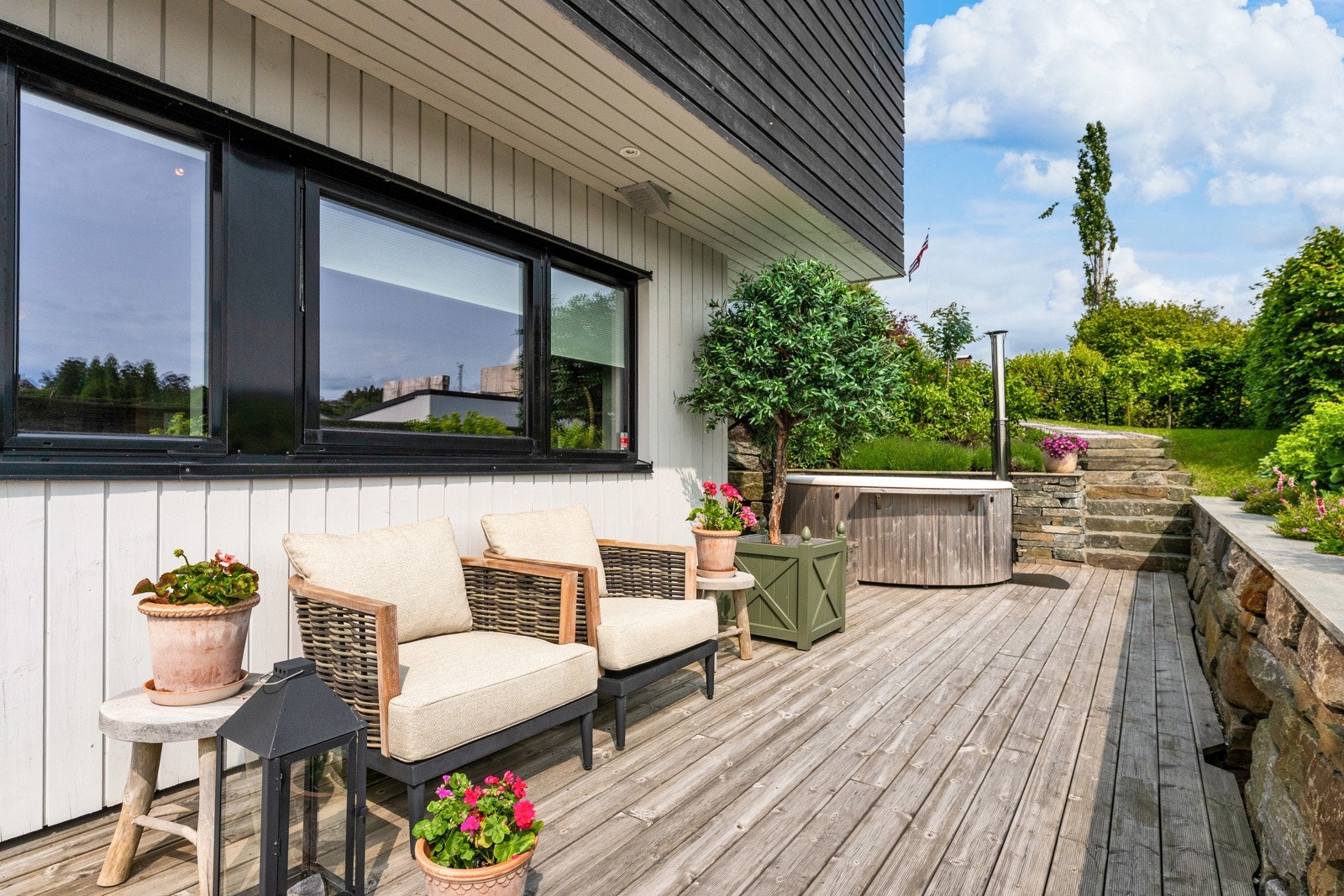 Den store terrassen i front av boligen har mange fine soner - Sørvendt beliggenhet gir gode solforhold Galleribilde