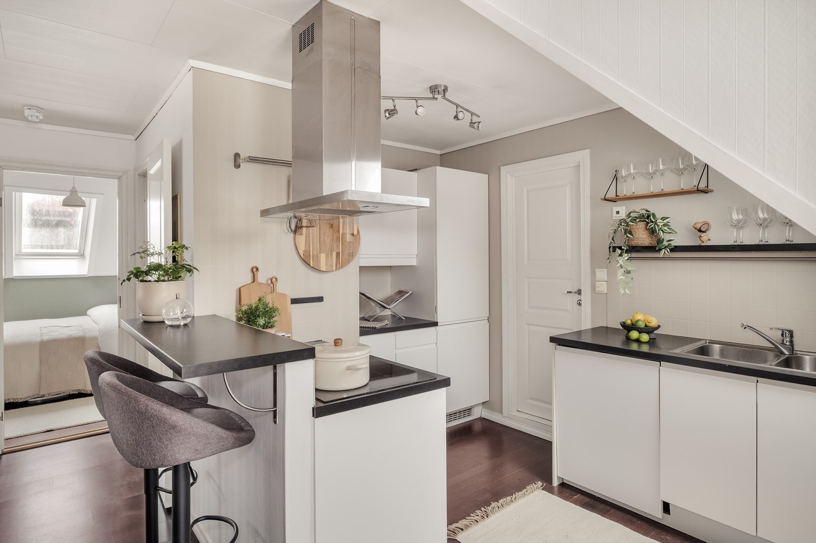 Lyst og innbydende kjøkkeninnredning med glatte fronter og laminert benkeplate. Kjøkkenet er utstyrt med integrerte hvitevarer som oppvaskmaskin, stekeovn, platetopp og fryse-/kjøleskap. Galleribilde