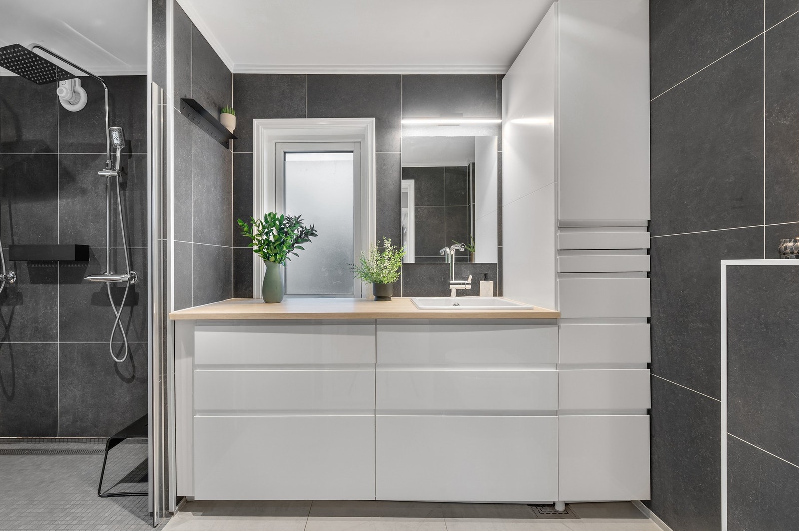 - Nyoppusset bad på hovedplanet med fliser på gulv og pen innredning. Galleribilde