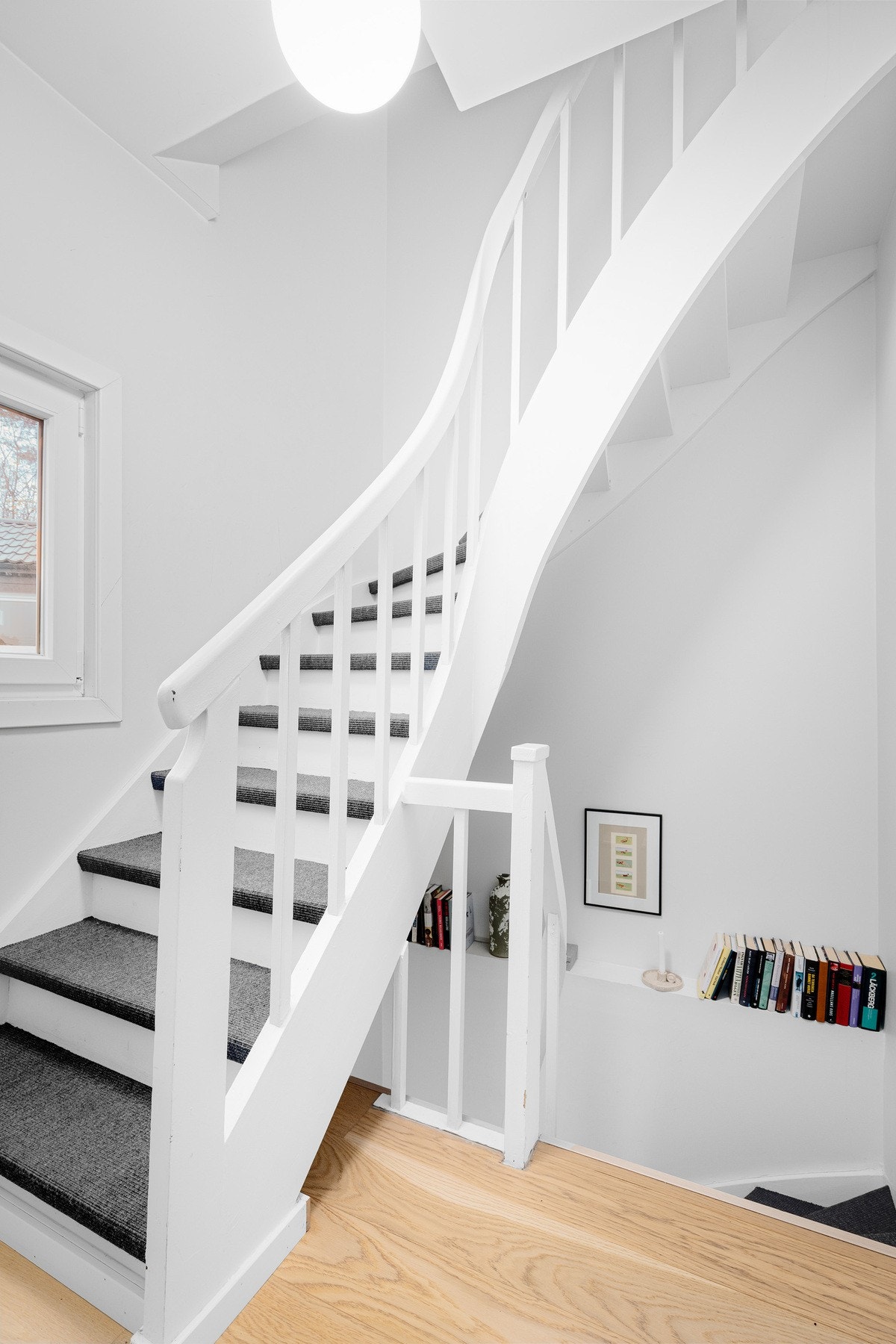 Innvendig halvsvingtrapp med tette trinn leder opp fra entréen til hovedetasjen. Trappen er hvitmalt og har teppebelagte trinn (nytt i 2017). Galleribilde