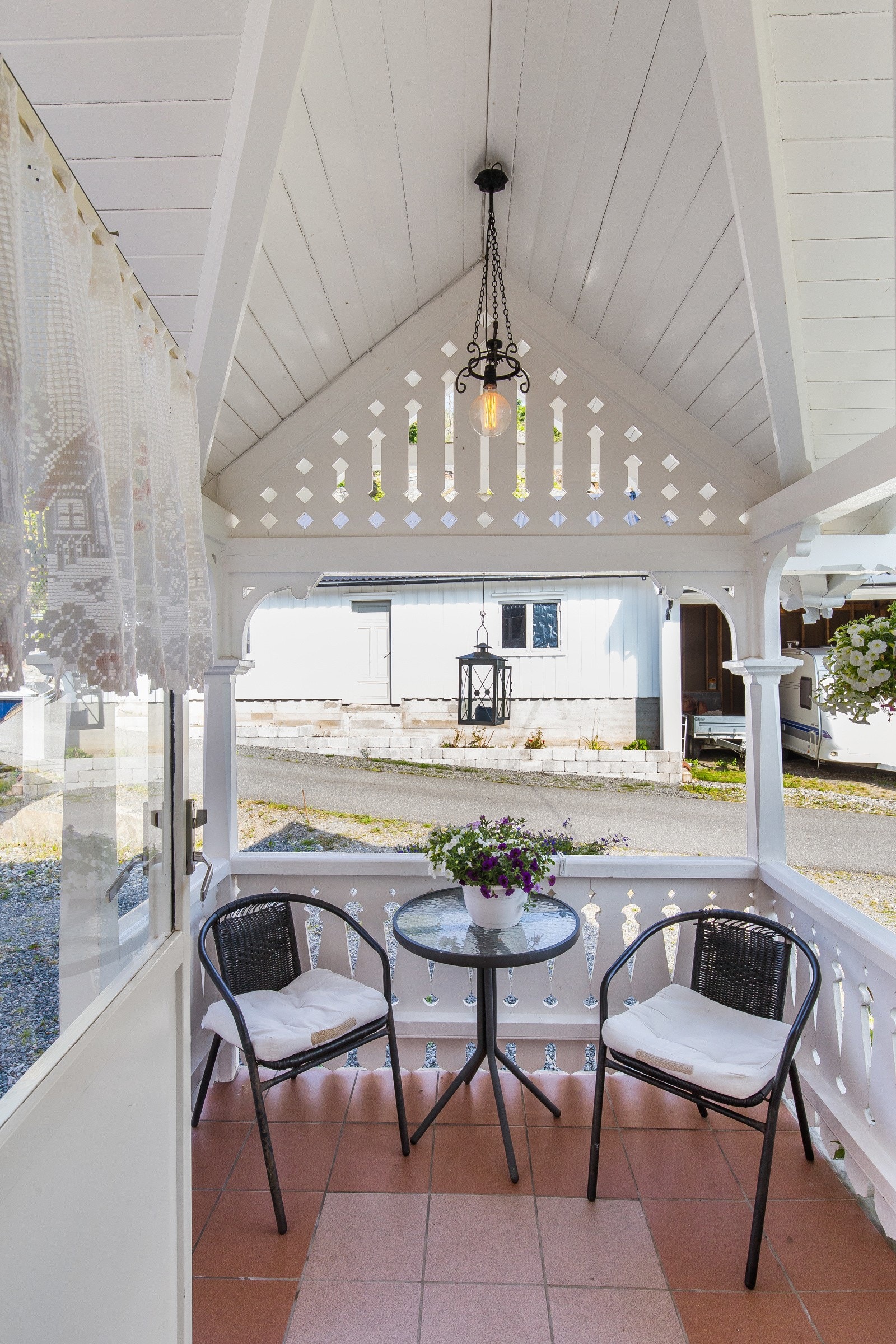 Koselig, overbygd uteplass med utsikt mot gårdsplass. Galleribilde