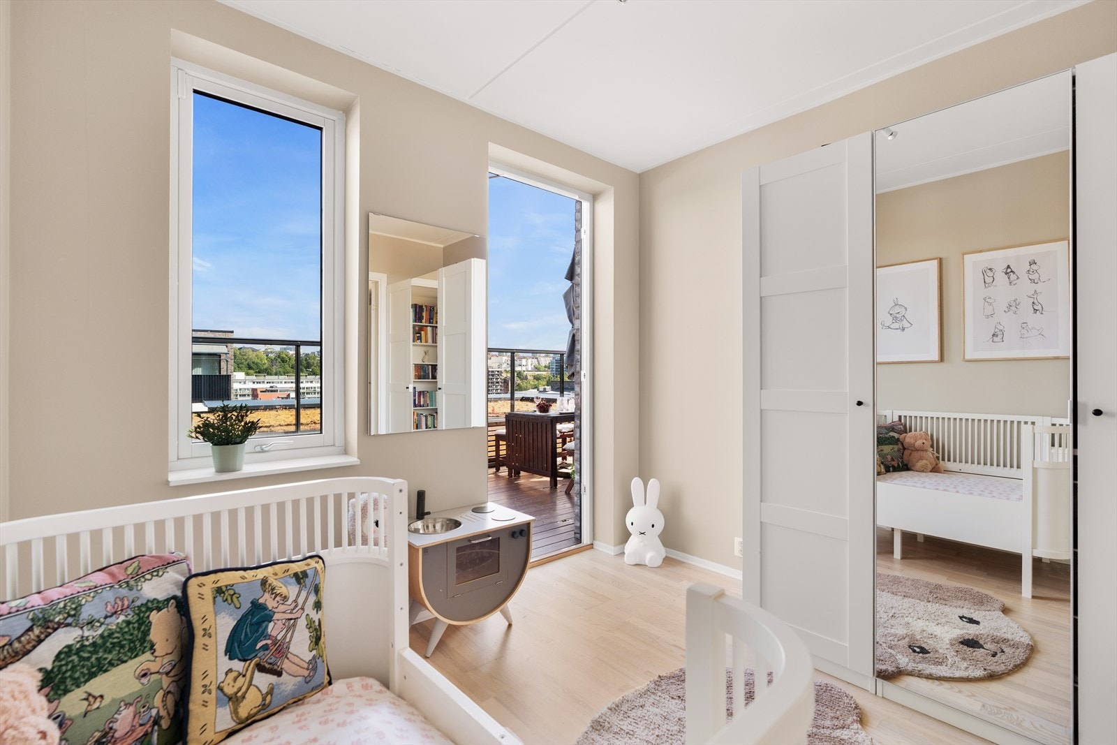 Leiligheten har tre soverom og dette rommet benyttes i dag som barnerom. Her det det godt med plass til garderobe, seng og lekeplass for de minste. I tillegg er det utgang til den privat takterrassen. Galleribilde