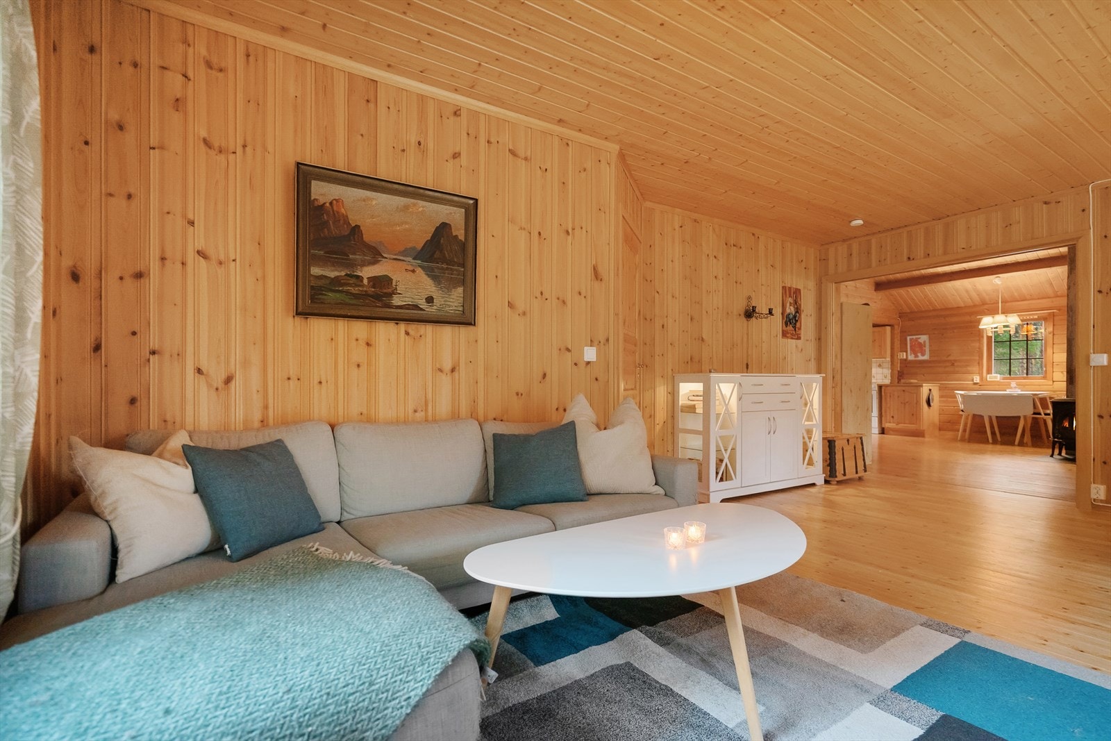 En innbydende krok for rolige kvelder med god bok eller peisvarme i bakgrunnen. Tidløst interiør som lar treverket og naturen være i fokus Galleribilde