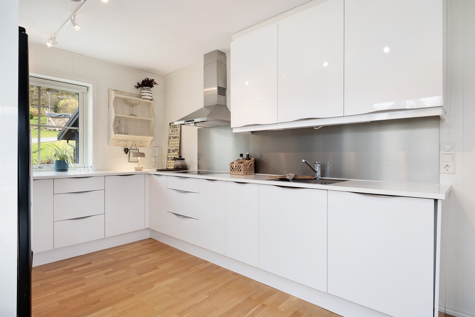 Kjøkkendelen har innreiing av skåpseksjonar med glatte måla frontar. Galleribilde