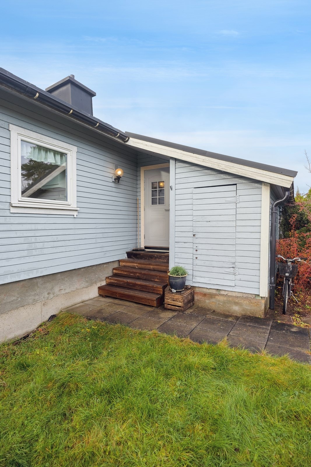 Overbygd inngangsparti med utvendig bod på siden. Galleribilde