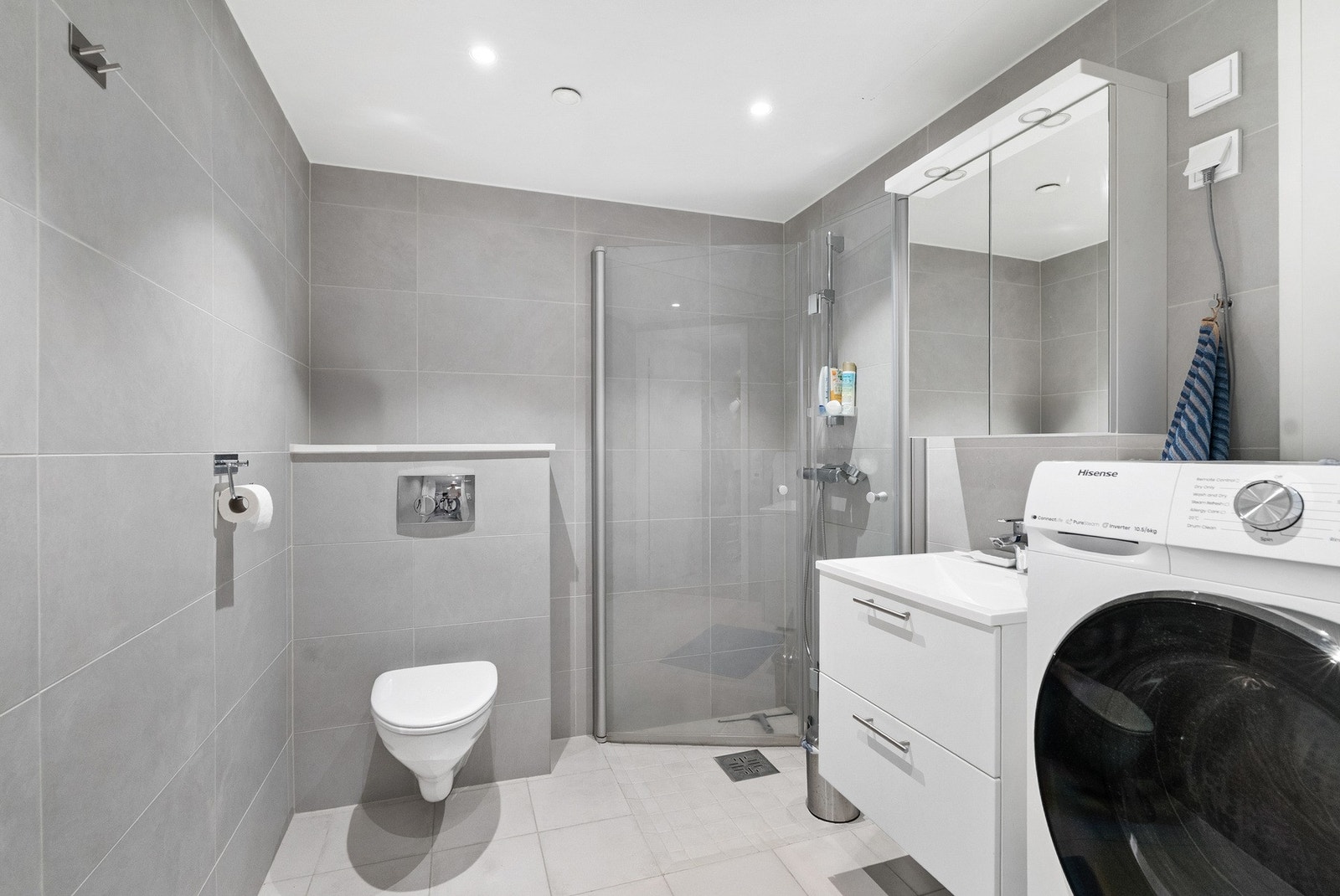 Lekkert og flislagt bad med varme i gulv. Moderne baderomsinnredning og speil m/integrert lys. Galleribilde