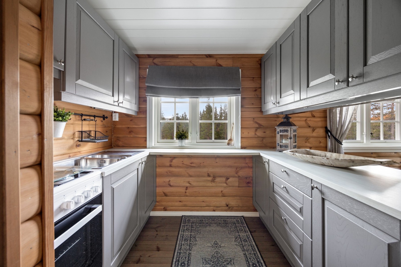 Stilren kjøkkeninnredning med gasskomfyr og oppvaskkum. Galleribilde