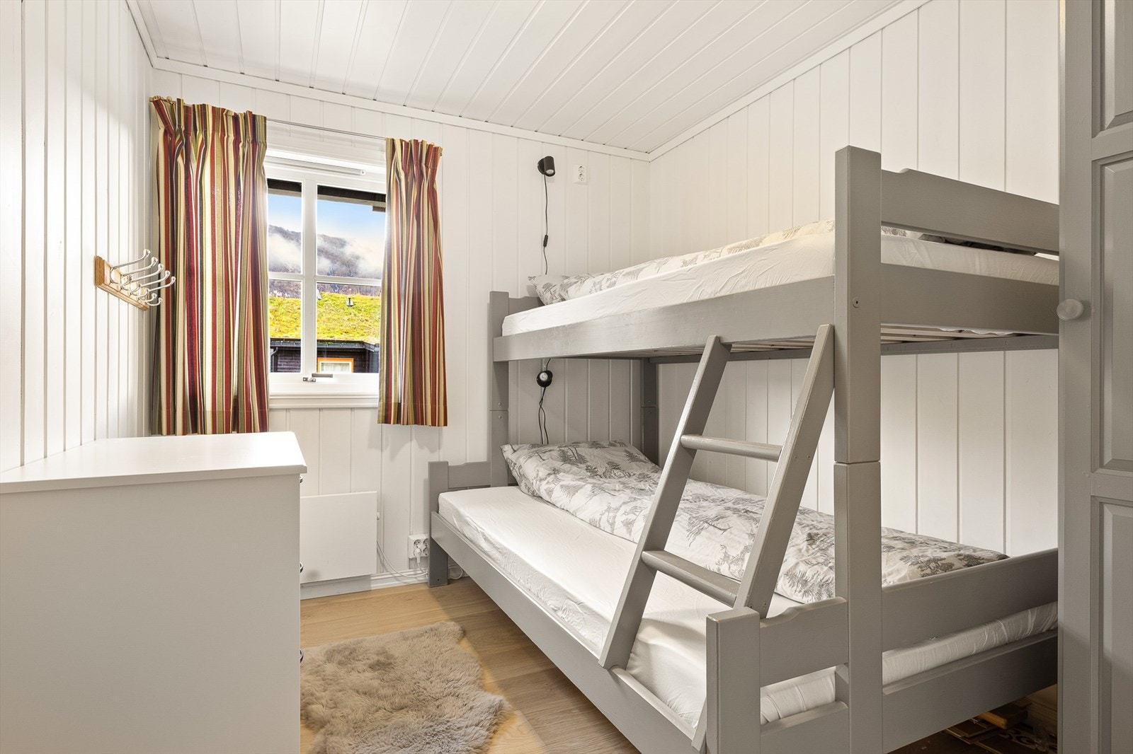 Det andre soverommet er av noe mindre størrelse, men har plass til familiekøye og klesoppbevaring Galleribilde