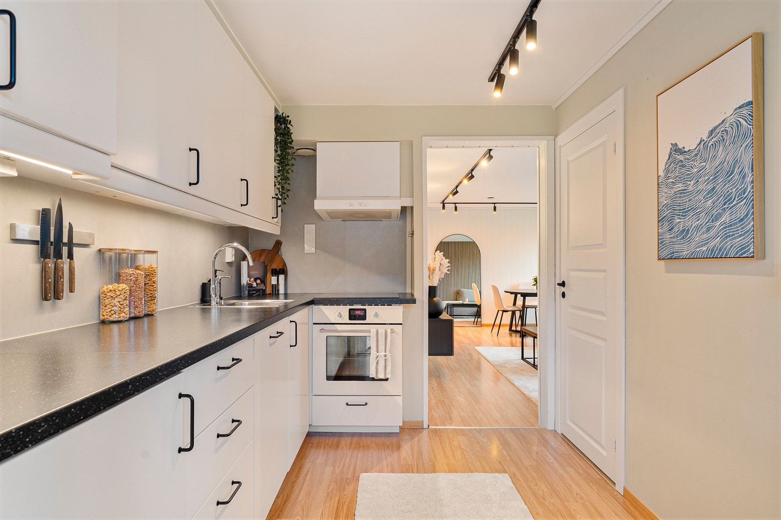 Ikea kjøkkeninnredningen fra 2013 er plassert i hendig vinkelform og har brede arbeidsflater, samt godt med lagringsplass i skap. Inn døren til høyre finner man soverommet. Galleribilde