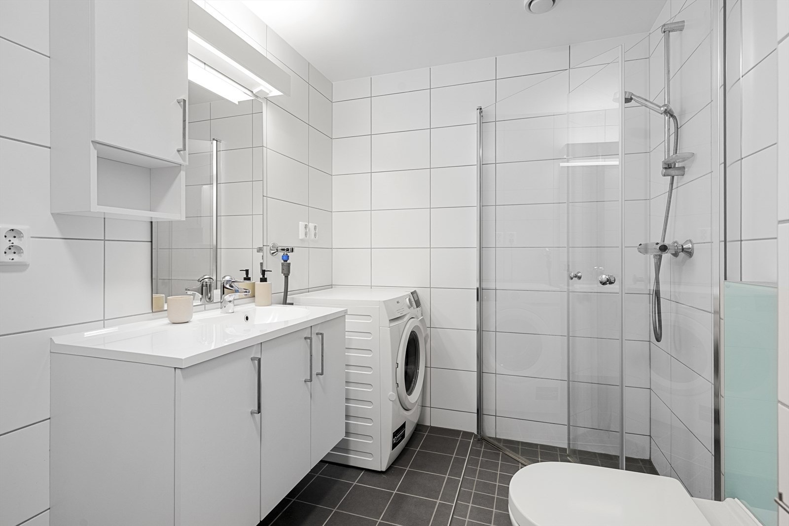 Flislagt baderom med opplegg for vaskemaskin og varmekabler i gulv Galleribilde