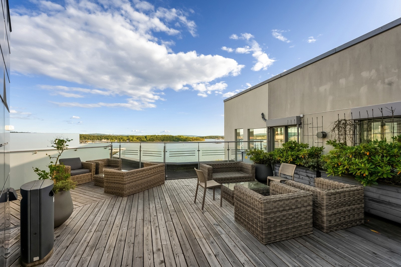 Felles takterrasse innredet med utemøbler og beplantning Galleribilde