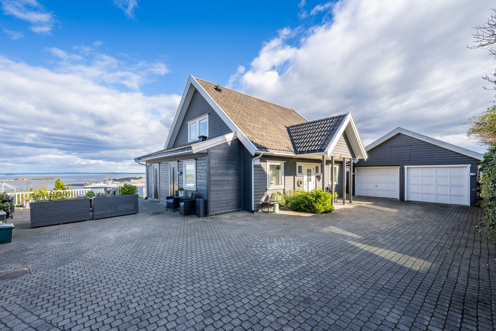 Steinsatt gårdplass og som vi ser kort vei fra dobbel garasjen og til inngangspartiet Galleribilde